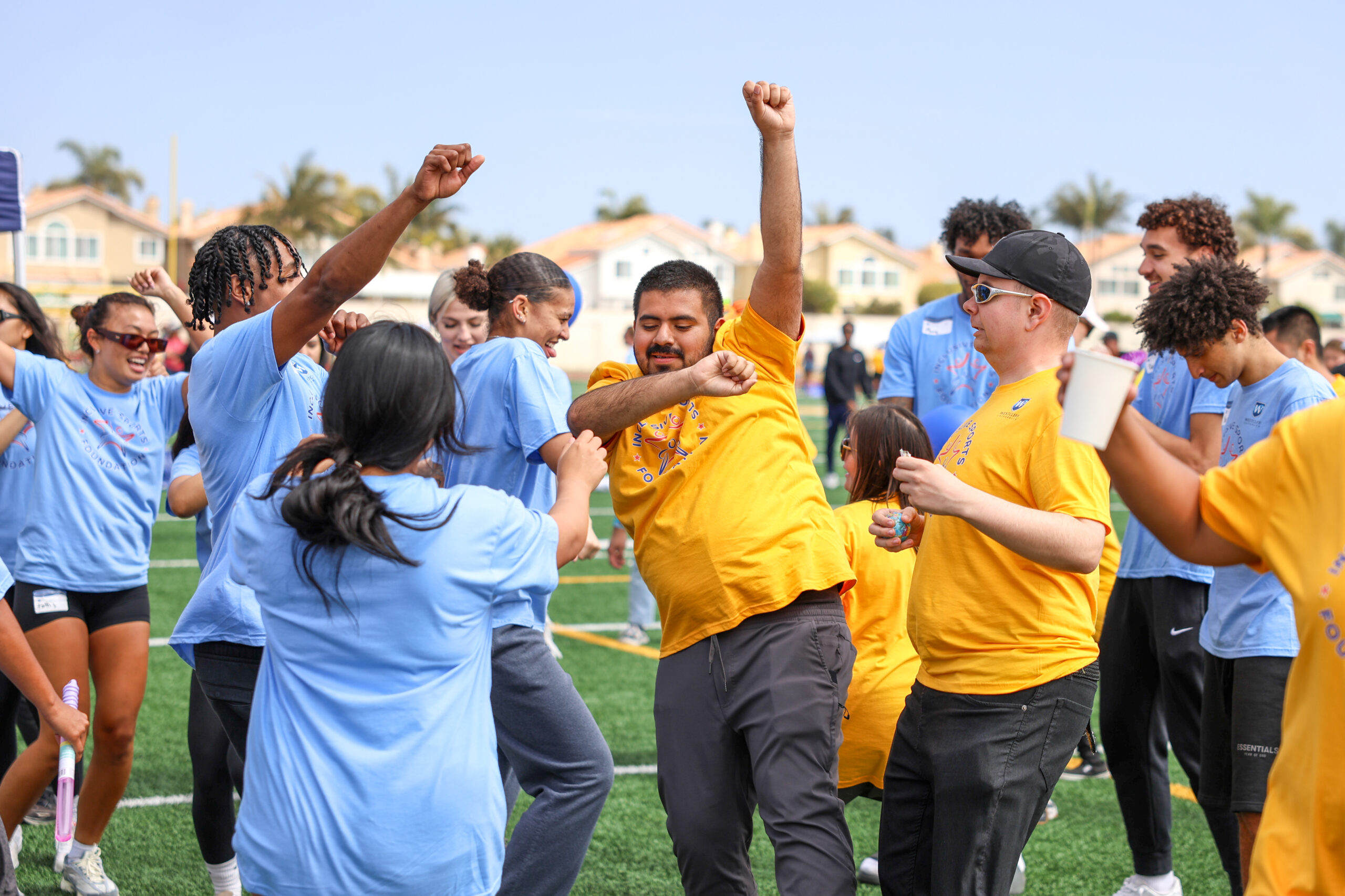 Huntington Beach Union High School District students dance alongside Westcliff University student-athletes as a DJ affiliated with the Los Angeles Rams plays music during Inclusive Sports Day.